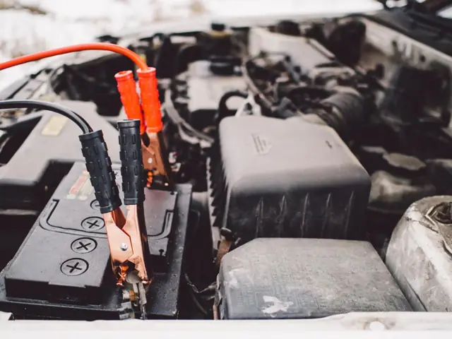 Jumper cables on a car battery during a no-start diagnosis