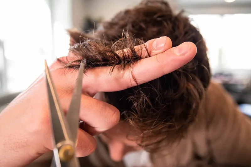 Stylist point-cutting the ends of a client's hair