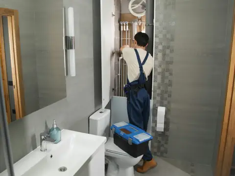 Plumber working in a bathroom